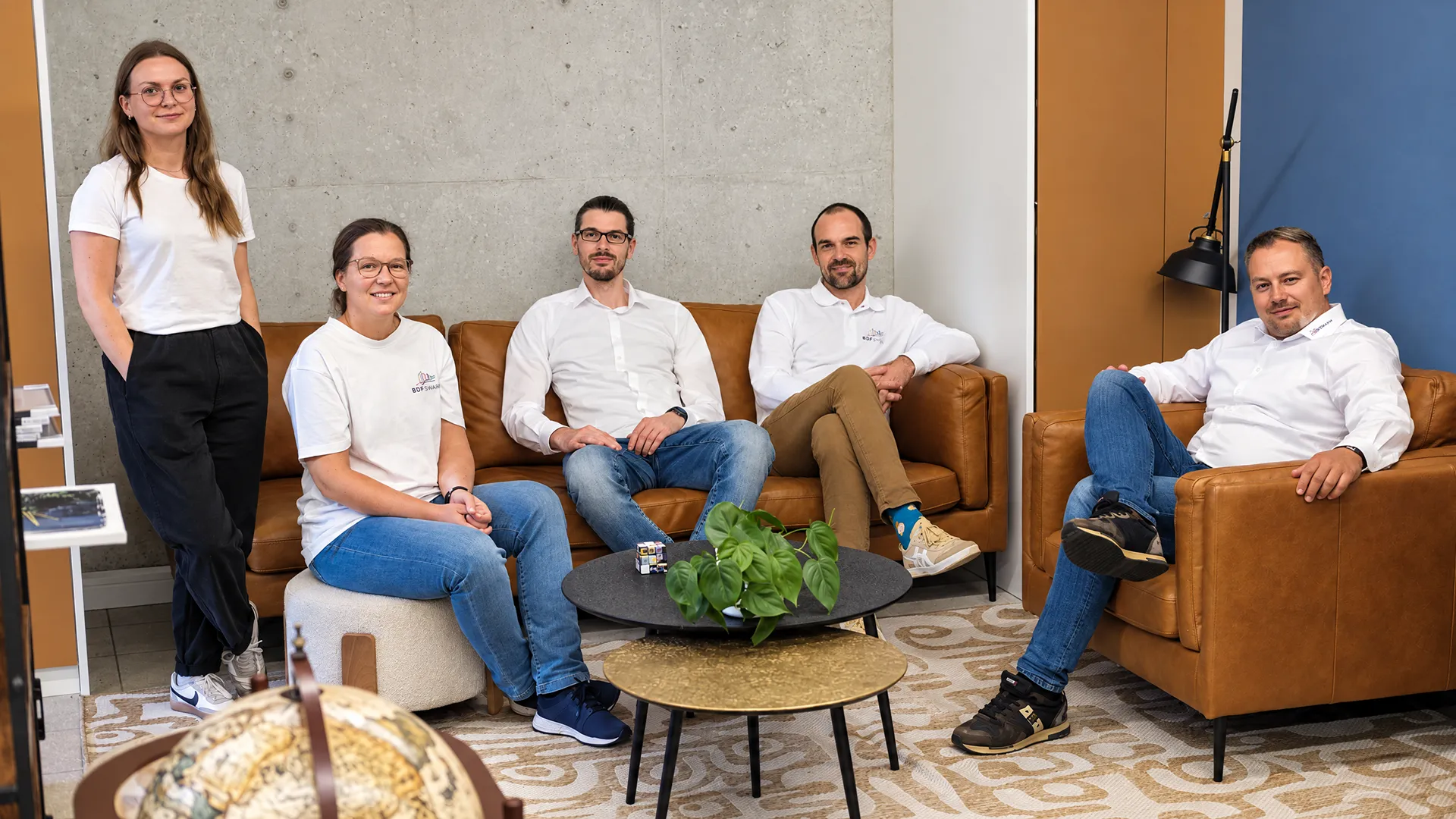 Five BDFsmart employees in the office lounge